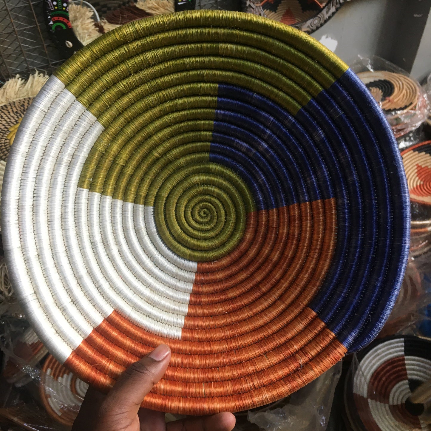 Colorful woven basket held by a hand with a blurred background