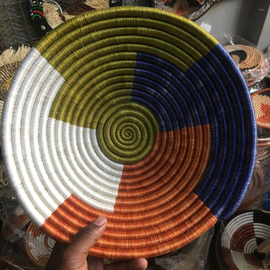 Colorful woven basket held by a hand with a blurred background